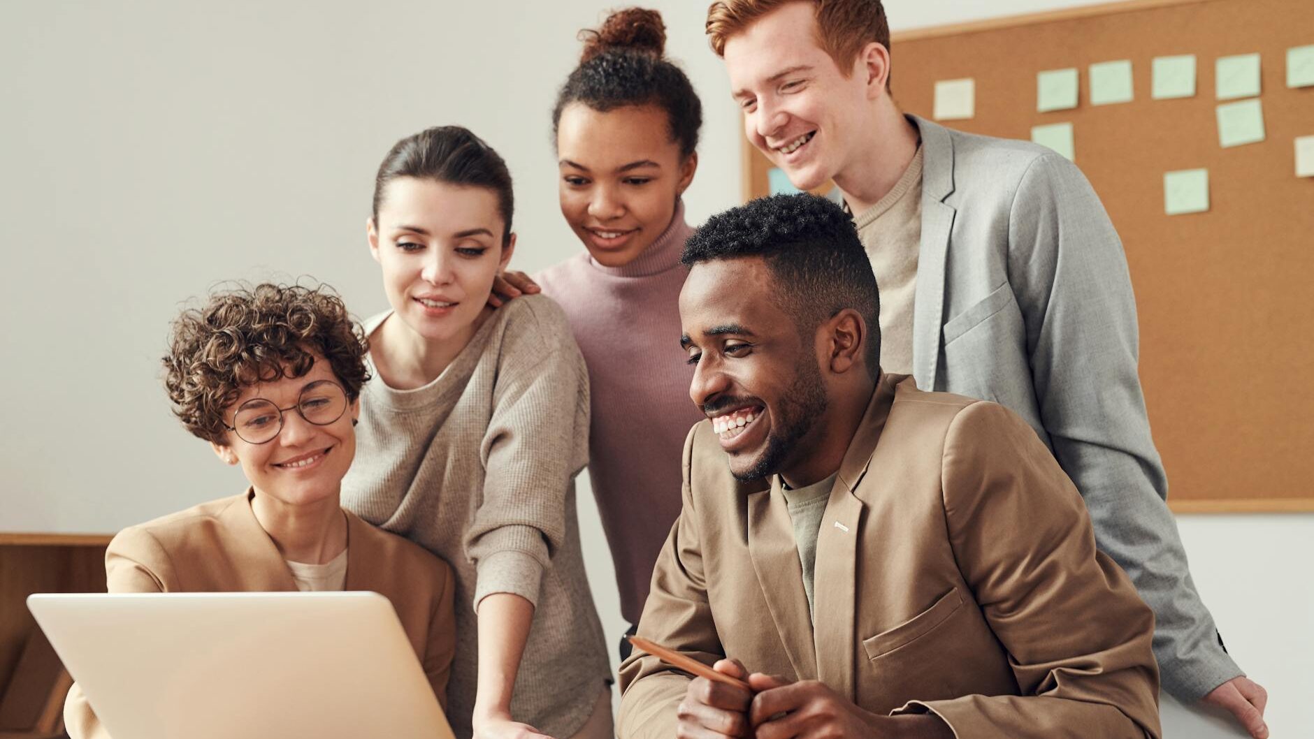 photo of people looking on laptop